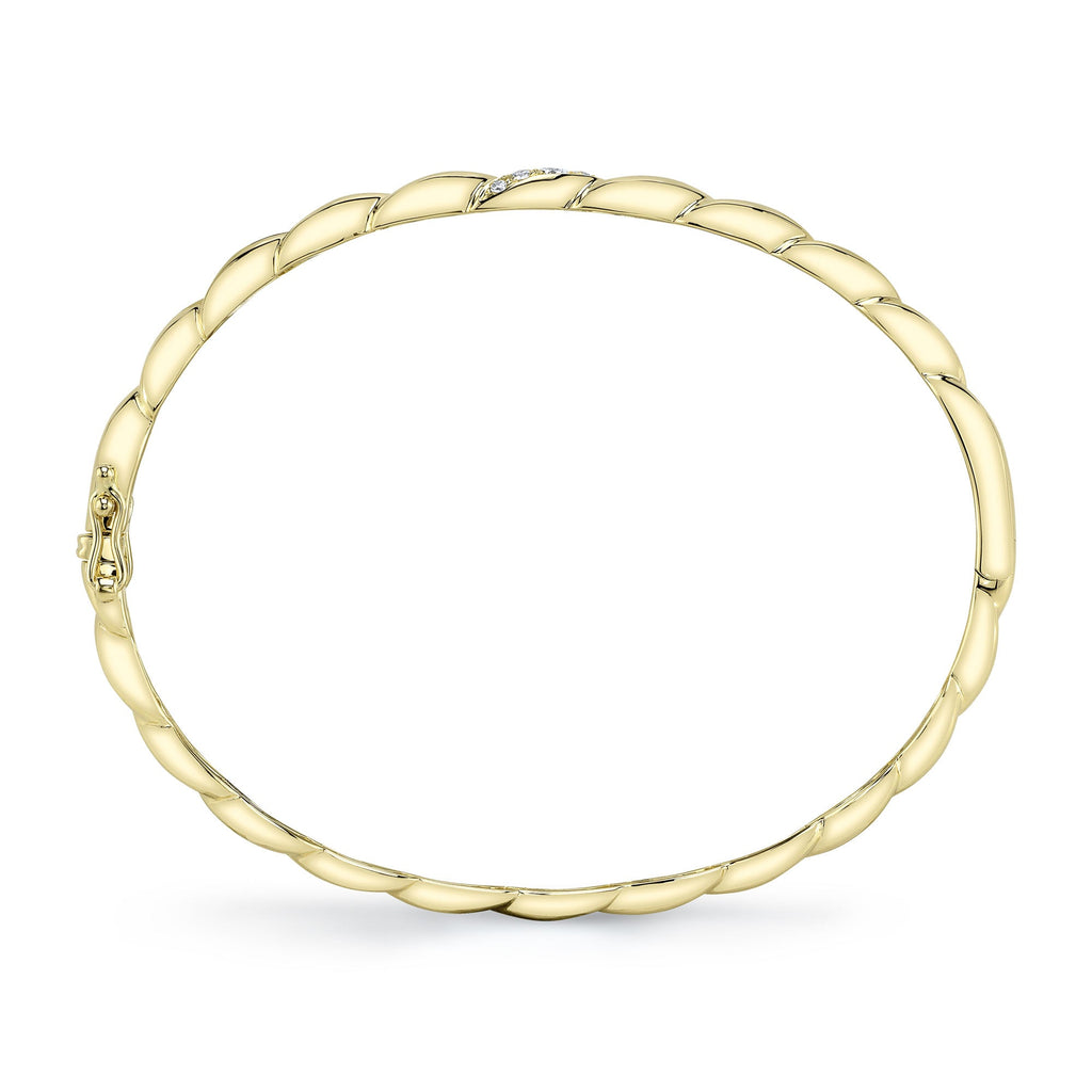 Yellow gold bangle with round diamonds.