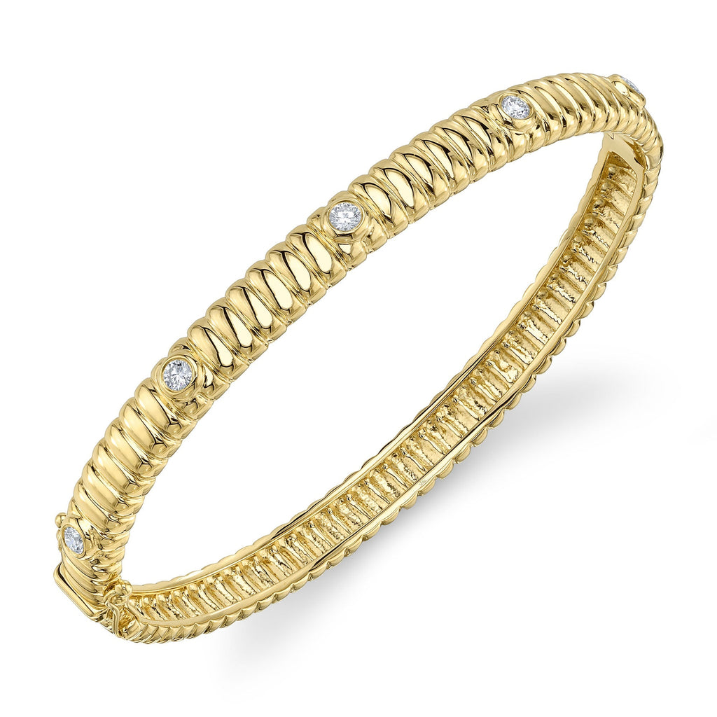 Yellow gold bangle with round diamonds.