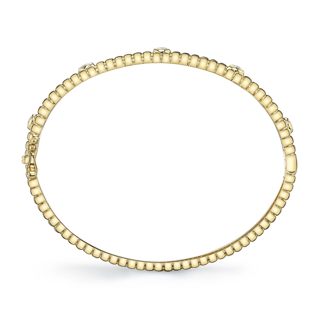 Yellow gold bangle with round diamonds.