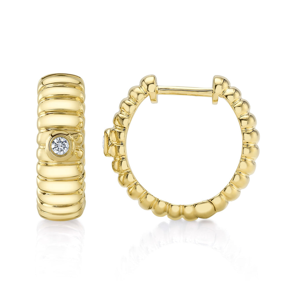 Huggie earrings with round diamond accents.