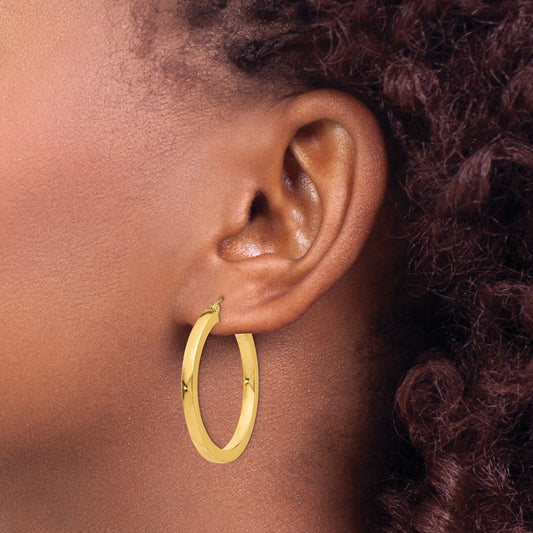 14K yellow gold medium hoop earrings.