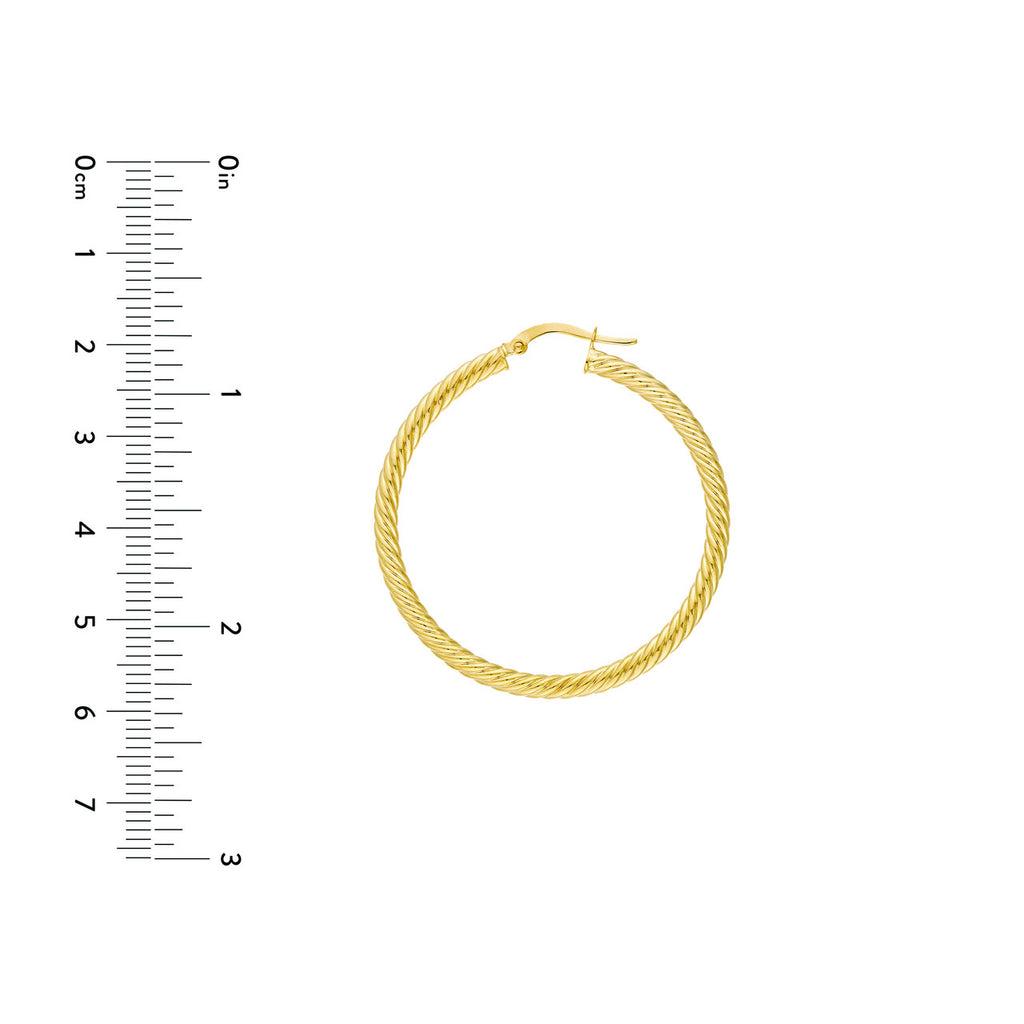 Twisted yellow gold hoop earring.