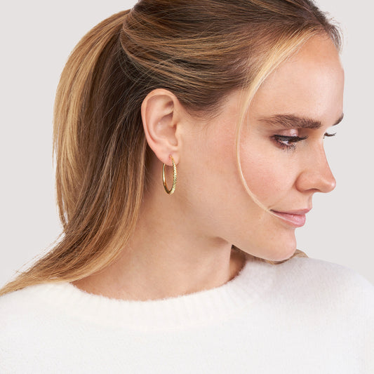 Diamond-cut 14K yellow gold medium hoops.