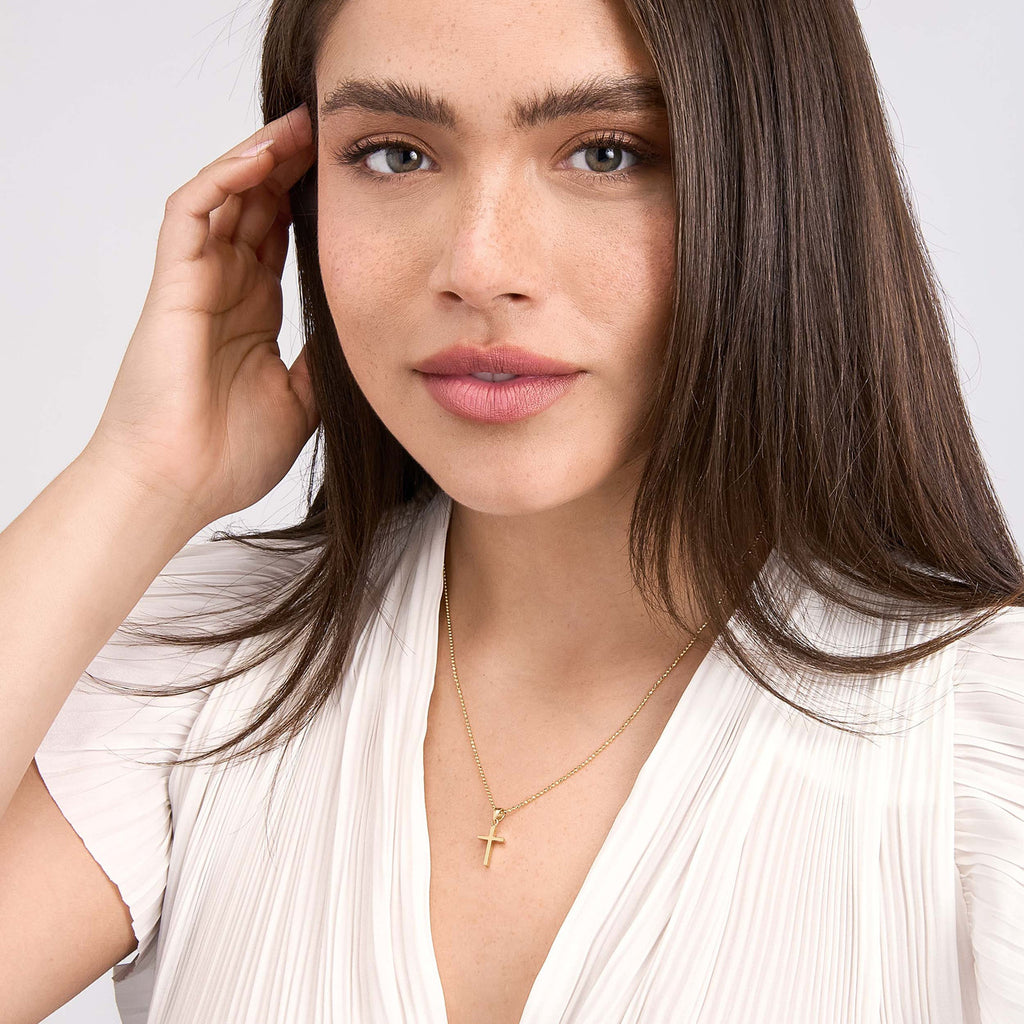 Dual-tone 14K gold cross necklace.