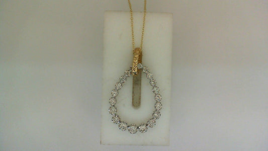 Teardrop diamond pendant on yellow gold chain.