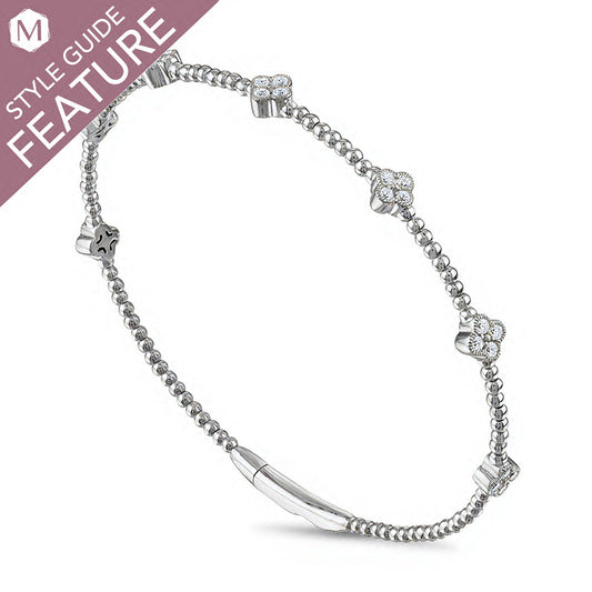 Flexible bangle with diamonds in white gold.