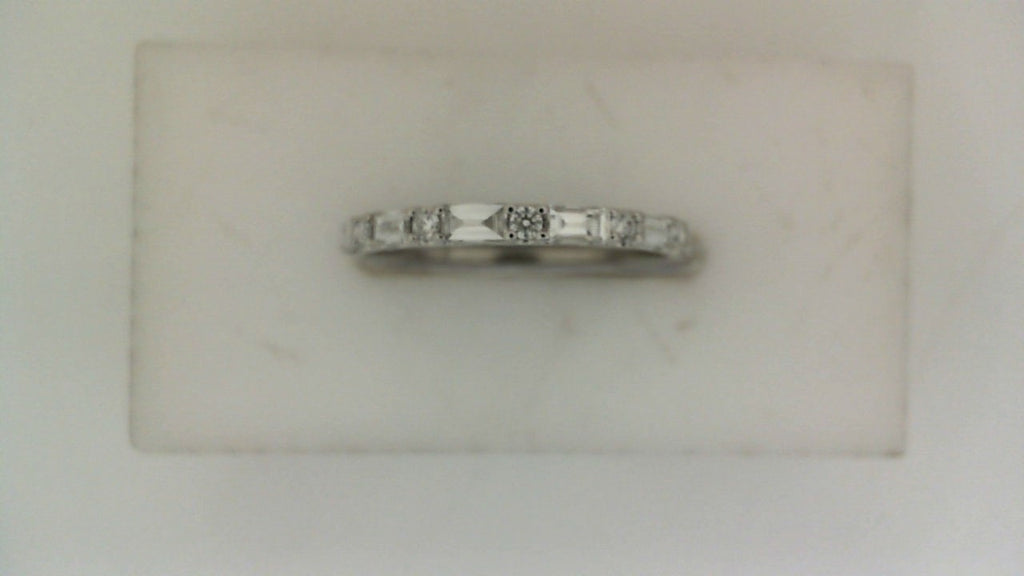 Front view of a white gold wedding band featuring alternating baguette-cut and round diamonds across the top.