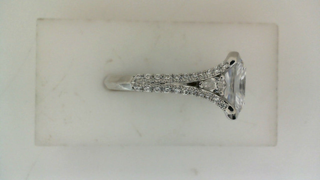 Side profile of a white gold diamond engagement ring with a pavé split shank and raised center-stone setting.