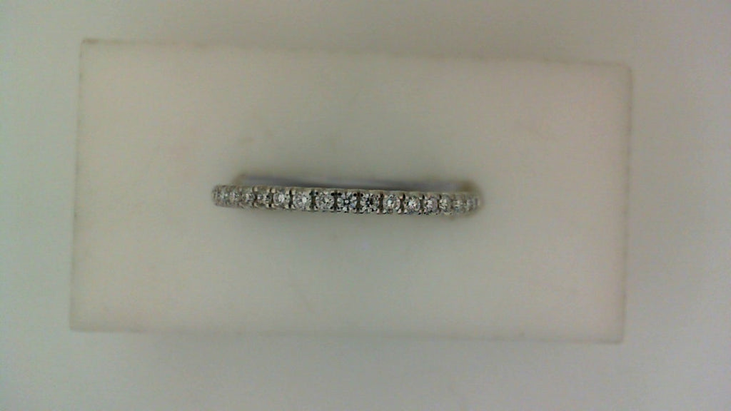 Front view of a slender white gold wedding band set with a row of small round pavé diamonds across the top.