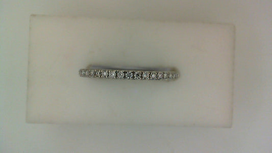 Front view of a slender white gold wedding band set with a row of small round pavé diamonds across the top.