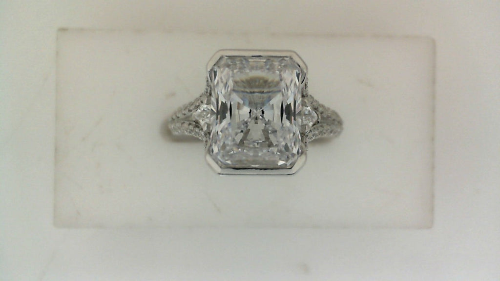 Front view of a white gold engagement ring featuring a large rectangular center diamond with diamond-accented shoulders.