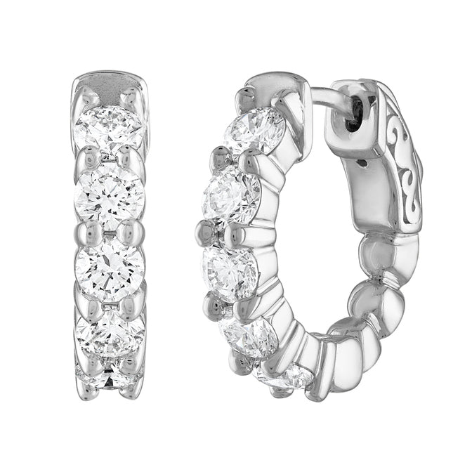 Front and side view of white gold hoop earrings featuring a row of round diamonds in prong settings.
