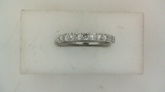 Front view of a white gold wedding band set with a row of round diamonds across the top.