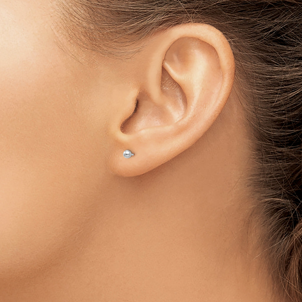 14K white gold stud earrings worn.