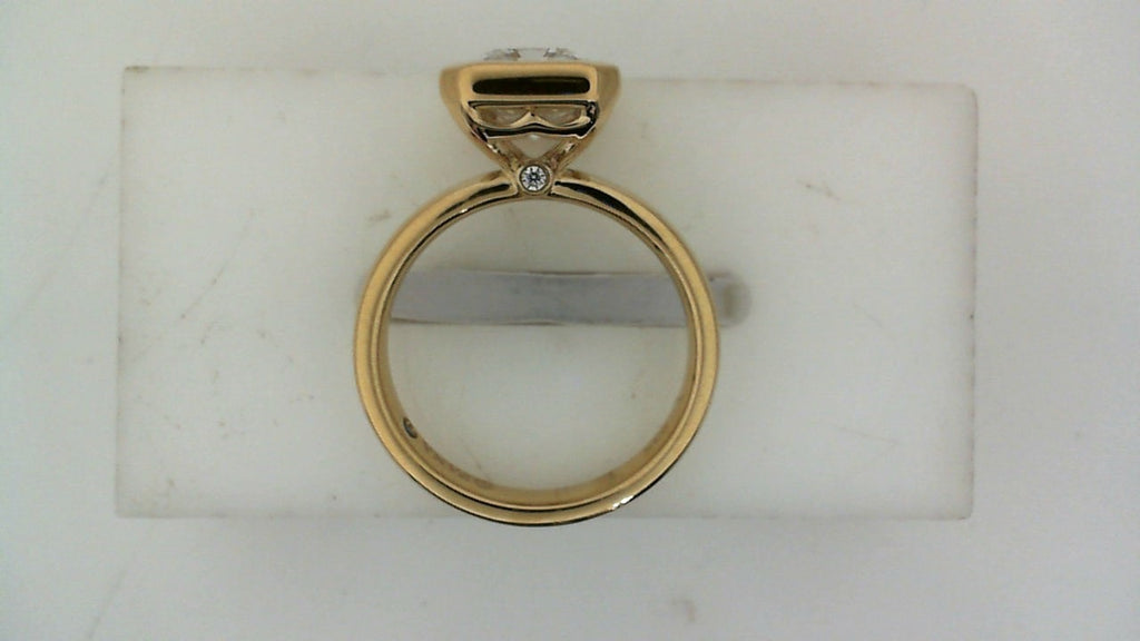 Side profile of a yellow gold diamond engagement ring with a raised center-stone setting and round diamond accent.