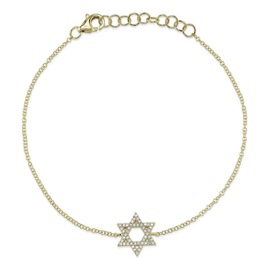 Gold bracelet with diamond star pendant.