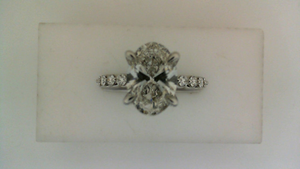 Oval diamond engagement ring with side stones.