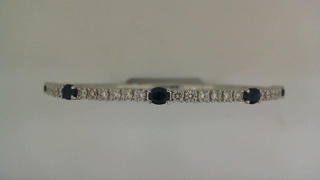 14K white gold bangle with sapphires.