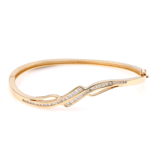 Yellow gold bracelet with wavy diamond design.