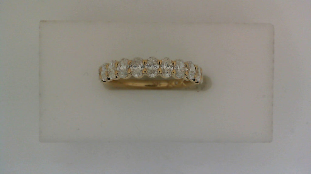 Oval diamond yellow gold wedding band.