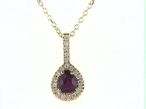 Pear-shaped ruby pendant with diamond accents.