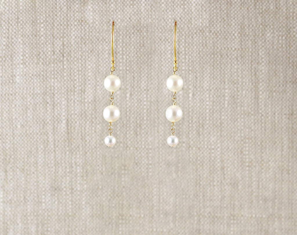 Gold-filled drop earrings with round pearls.