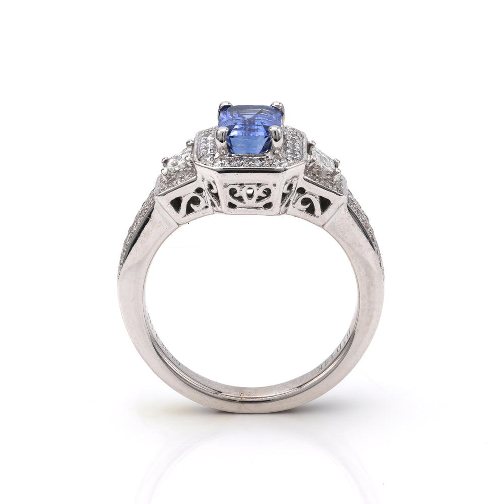 Emerald sapphire ring with diamond accents.