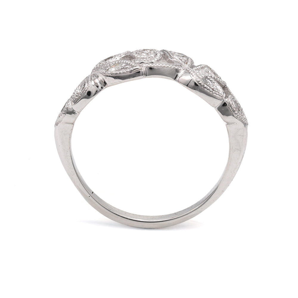 Platinum ring with round diamond accents.