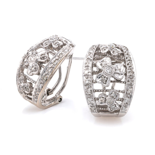 Floral diamond huggie earrings in white gold.