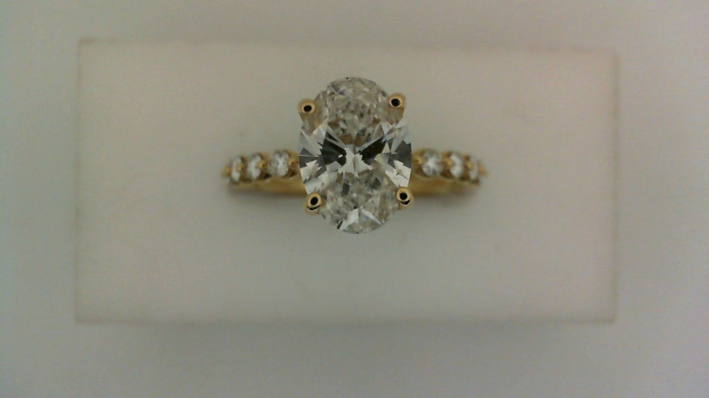 Oval diamond yellow gold engagement ring.