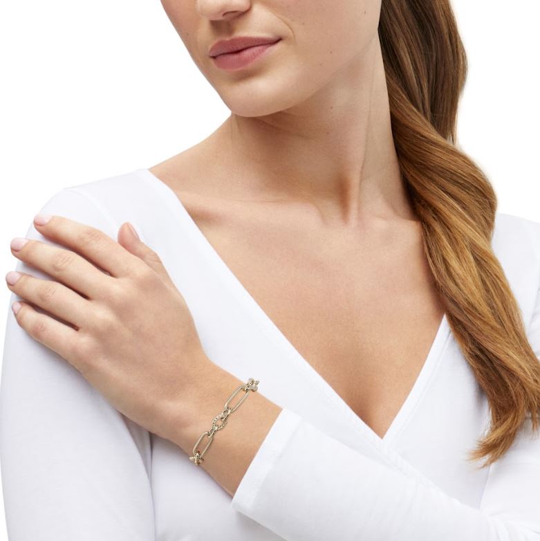 14K yellow gold station bracelet worn.