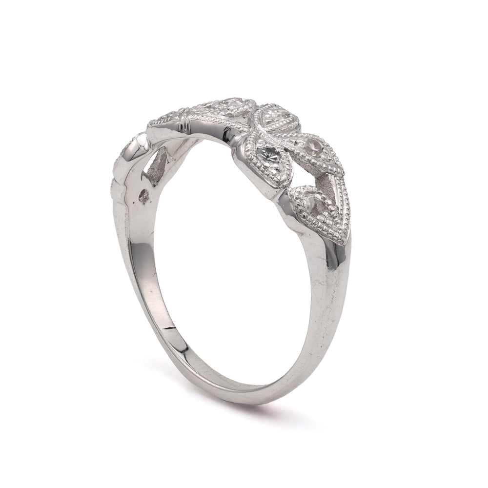 Platinum ring with round diamond accents.