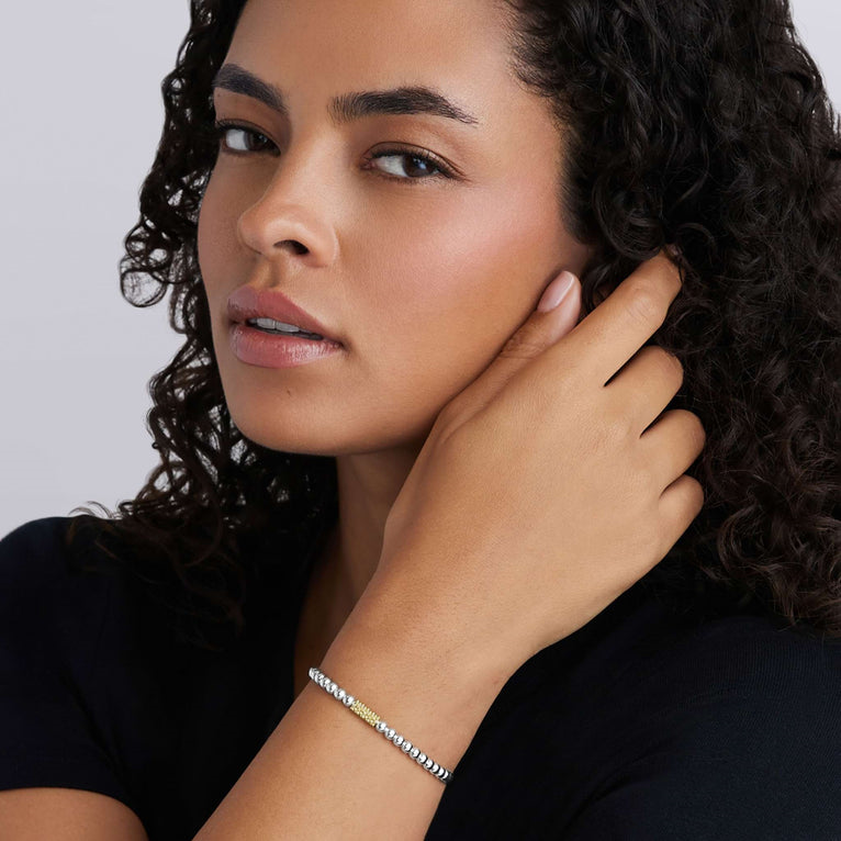 Sterling silver stretch bracelet with tri-color design.