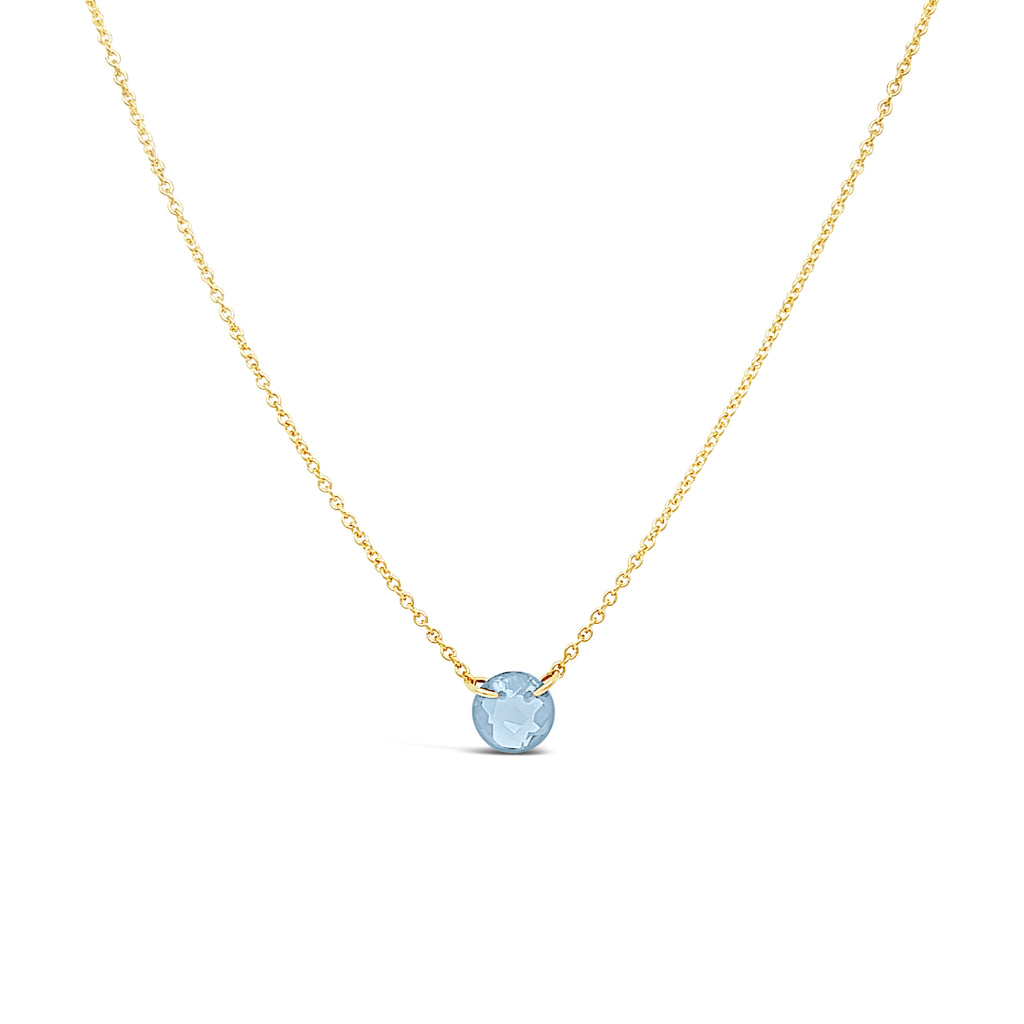 Gold necklace with round aquamarine pendant.