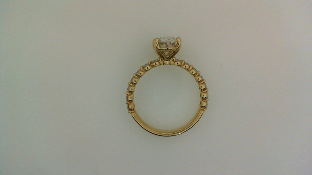 Oval diamond yellow gold engagement ring.