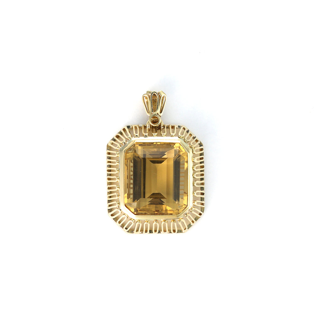 Emerald-cut citrine pendant in yellow gold.