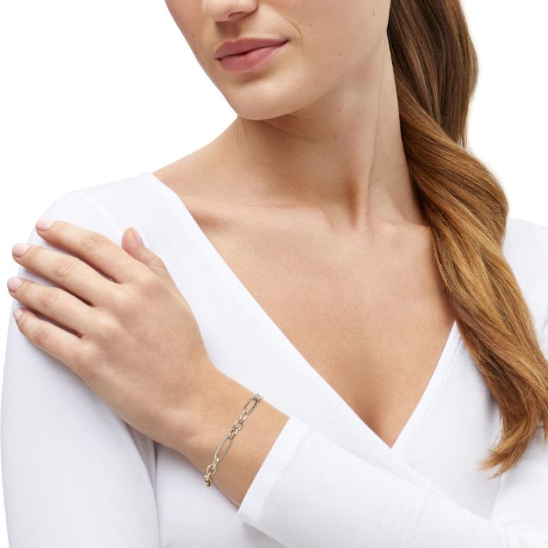 14K yellow gold minimalist bracelet on wrist.