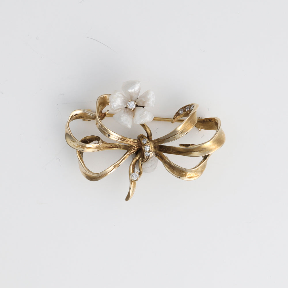 Floral bow pin with pearls, diamonds, gold.