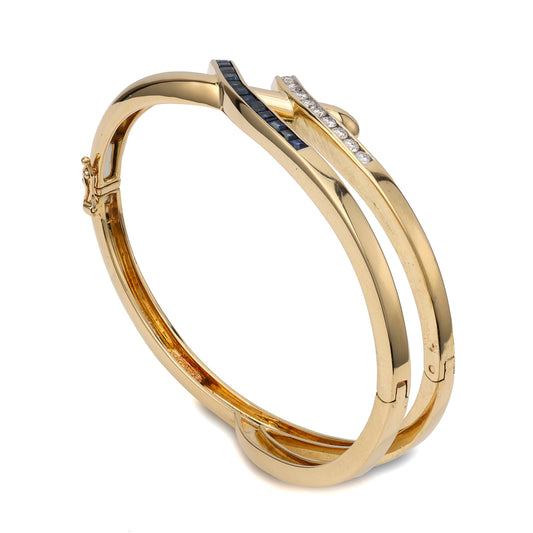 18K gold bangle with diamonds, sapphires.