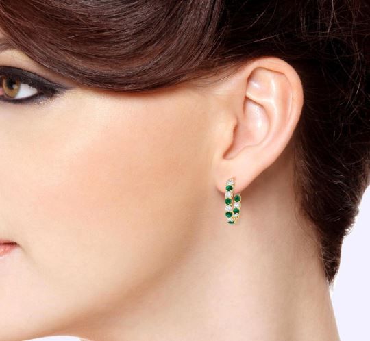 Small hoop earrings with emeralds and diamonds.