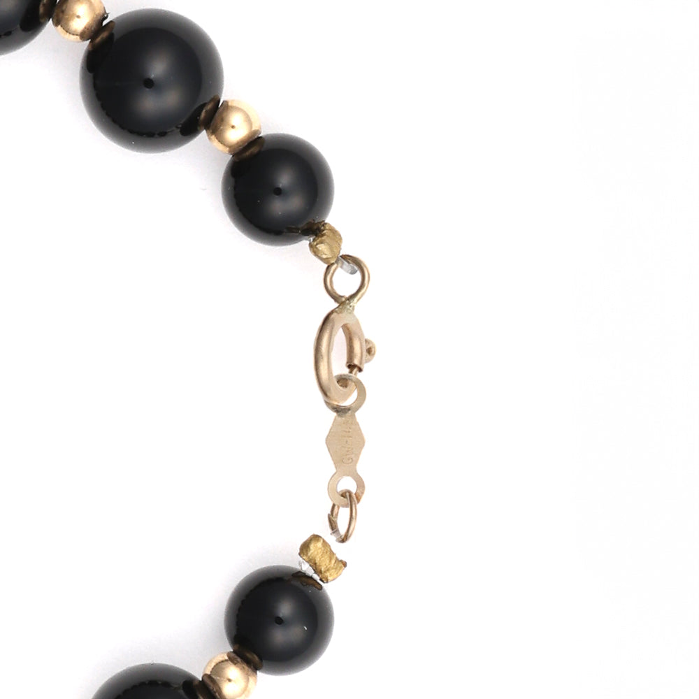 14K gold bracelet with black onyx beads.