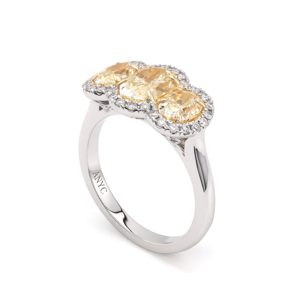 Oval yellow diamond halo engagement ring.