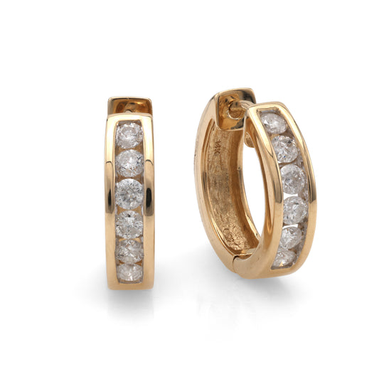 14K yellow gold huggie diamond earrings.
