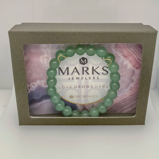 Green aventurine stretch bracelet in packaging.