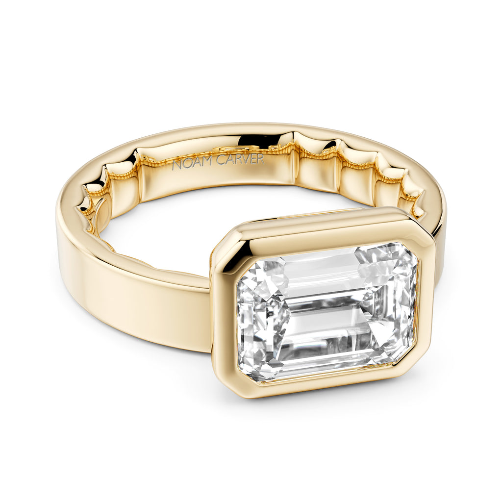 Yellow gold ring with emerald-cut diamond.