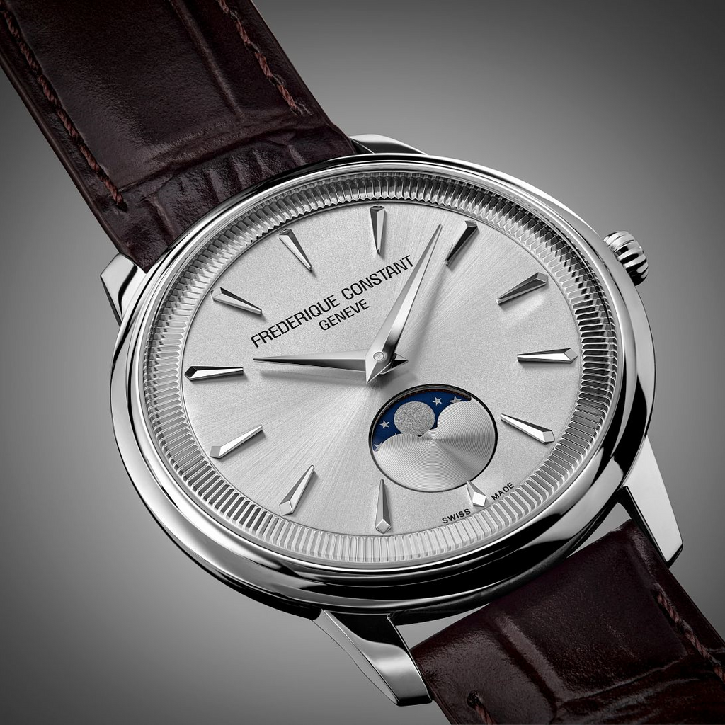 Silver dial watch with moon phase display.