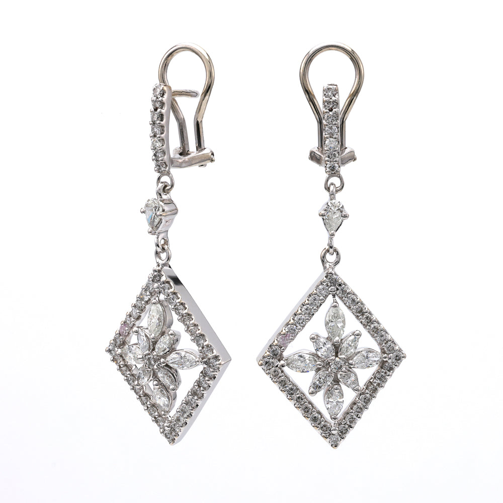 Diamond dangle earrings with geometric floral design.
