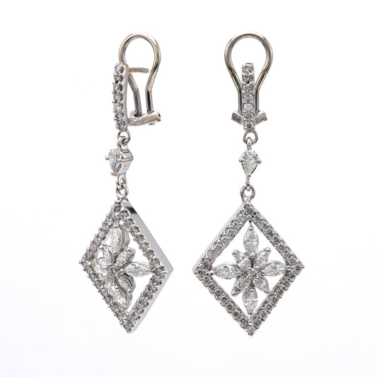 Diamond dangle earrings with geometric floral design.