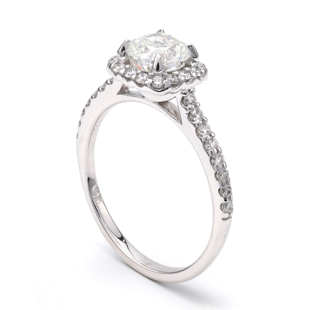 Cushion diamond halo engagement ring in white gold.
