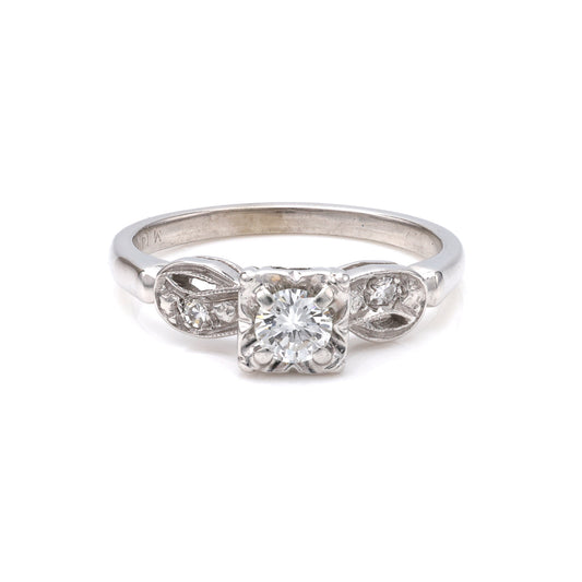 Vintage three-stone diamond ring in white gold.